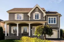 A traditional home gets a second floor over its garage. Great results!